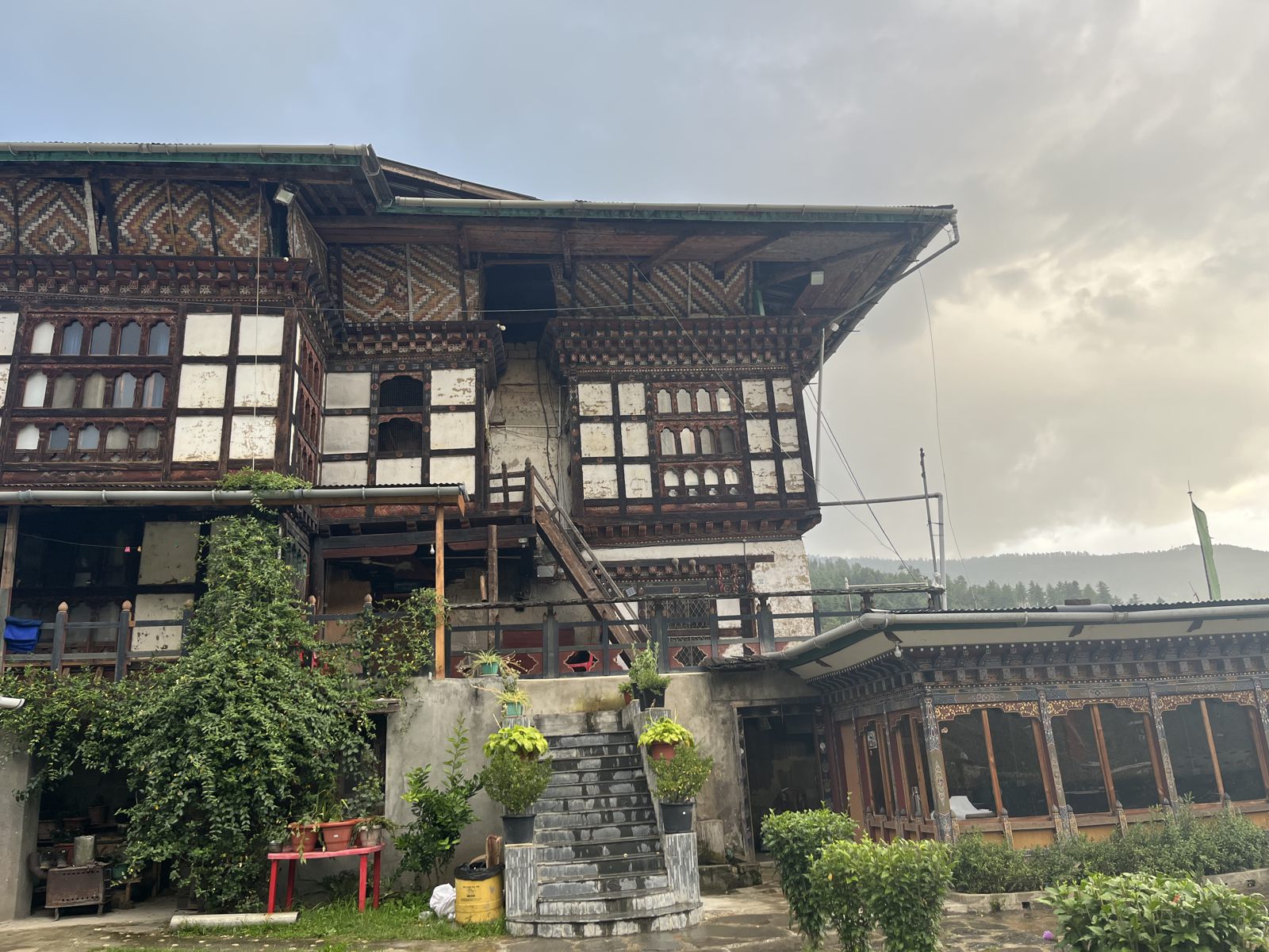 A traditional Bhutanese farmhouse under an evening sky
