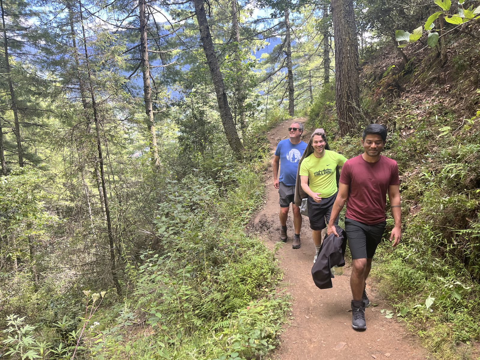 Scholars hiking a forest trail outside Thimphu