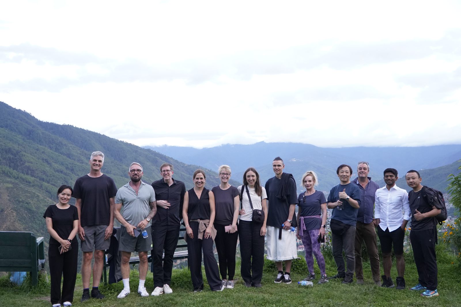 The Forum group lined up on a ridge with mountains behind