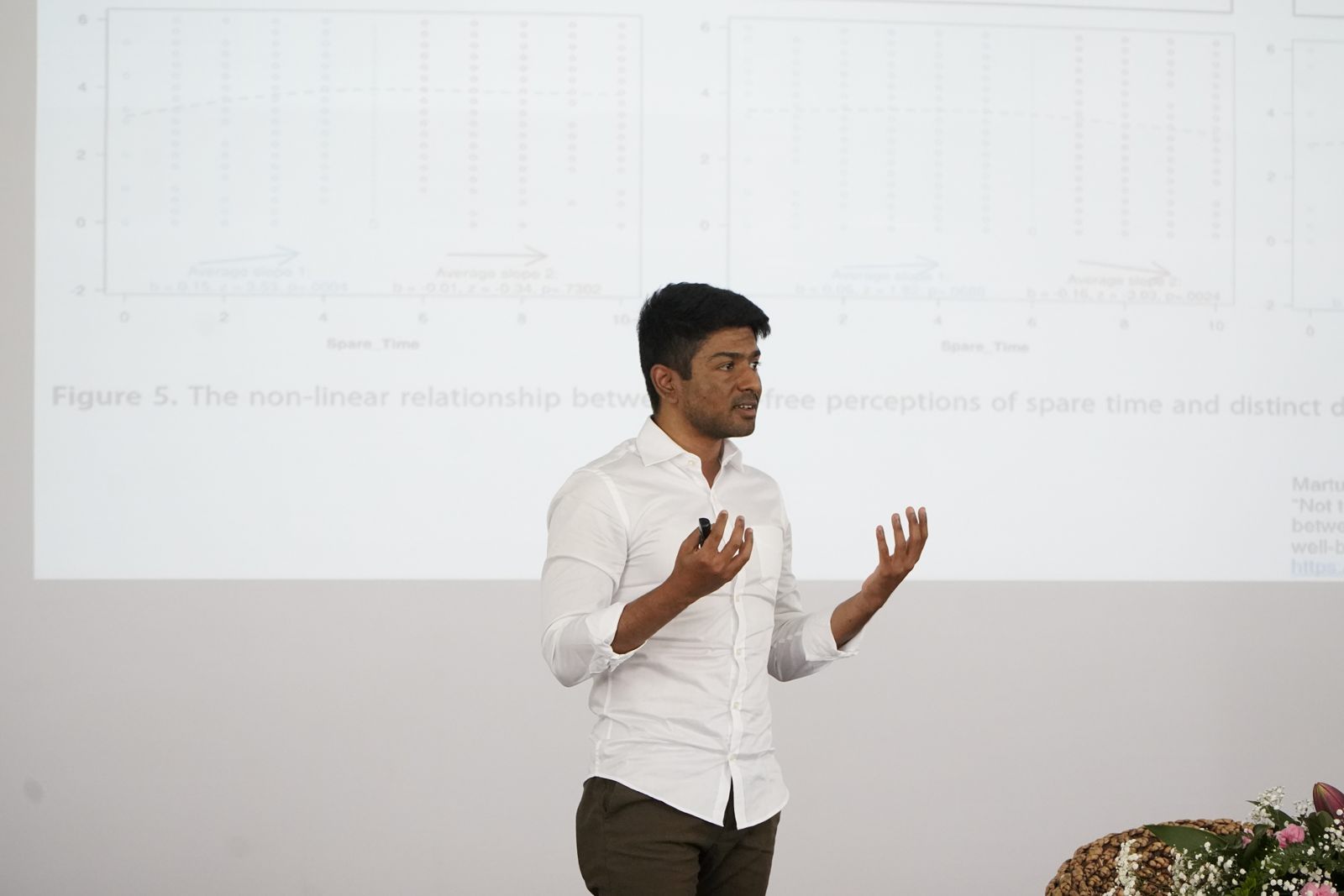 A scholar presenting research charts at the forum in Bhutan